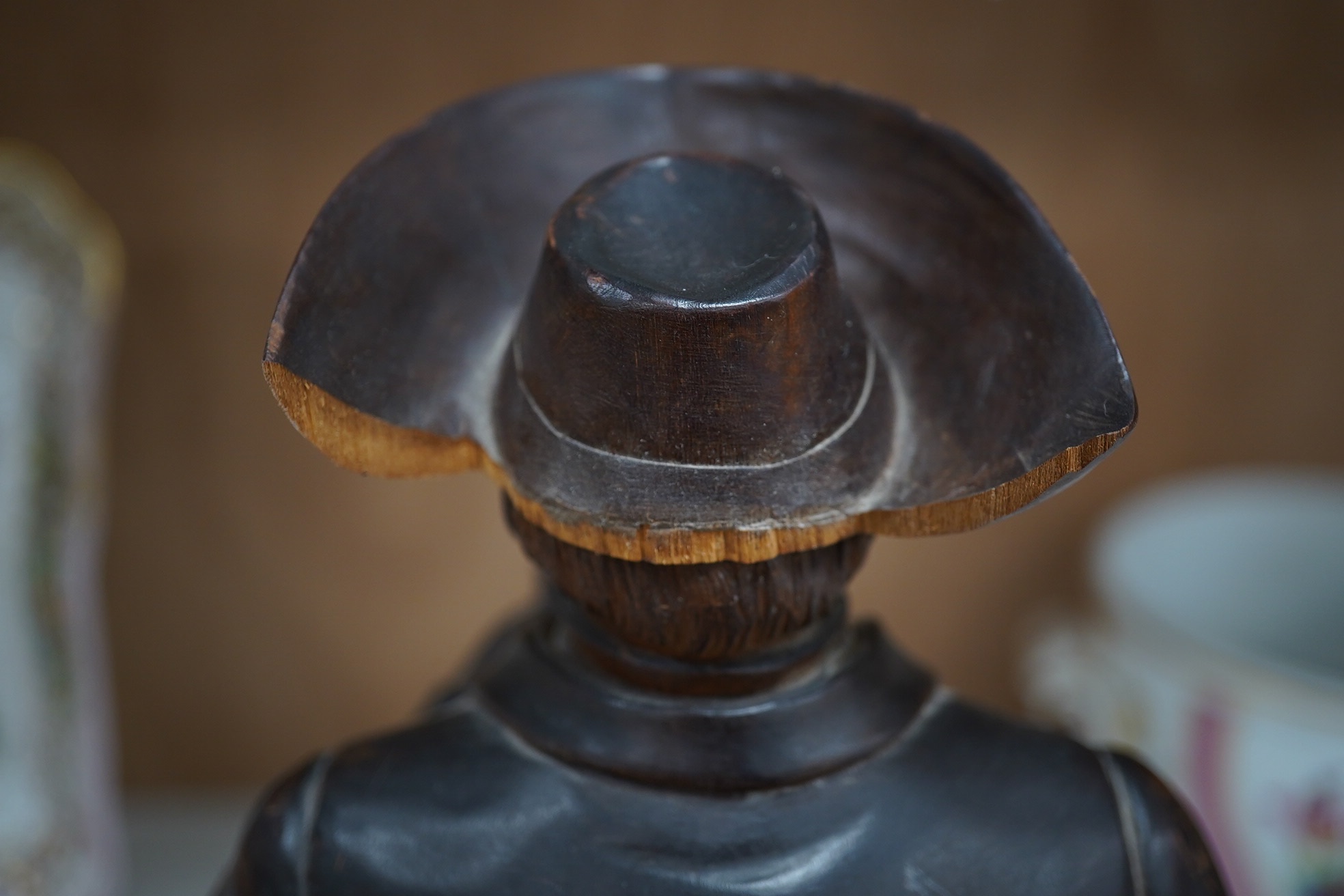 A 19th century Black Forest figure of a gentleman smoking a pipe, hinged at the waist to hold tobacco?, 36.5cm high. Condition - poor to fair, the shaft of his pipe is missing and the rear section of his hat